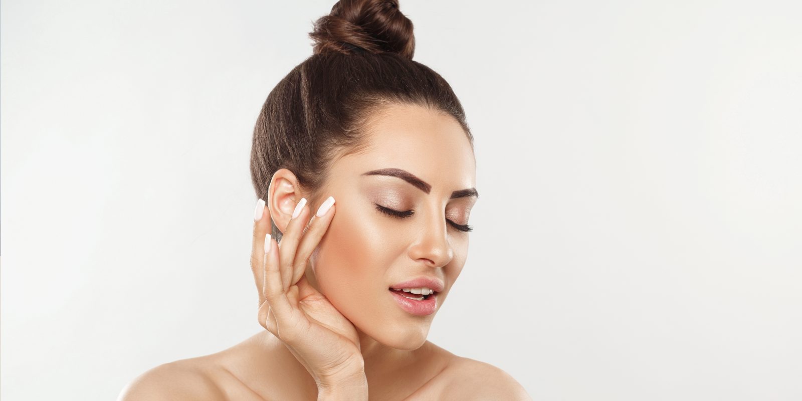 Glowing client after a treatment at The HydraFacial Club