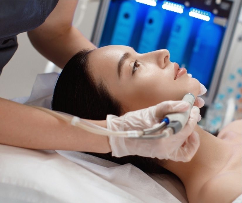 Esthetician performing a HydraFacial treatment at The HydraFacial Club in Calgary